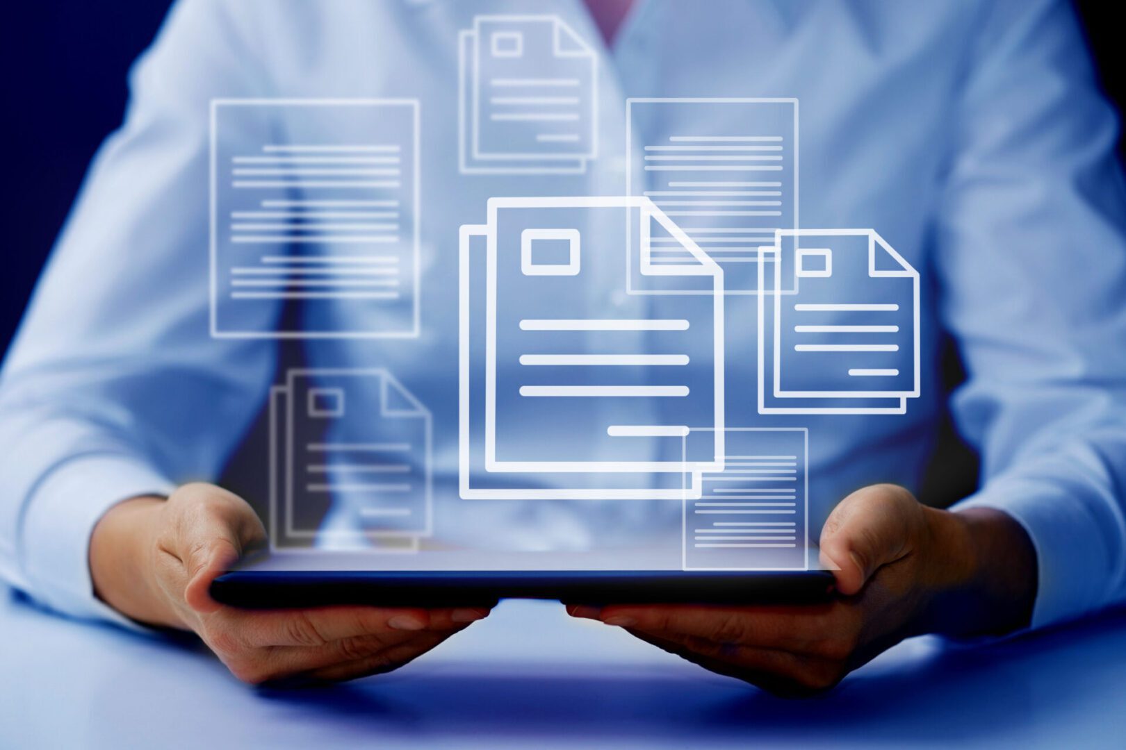 Person holding tablet with digital document icons.